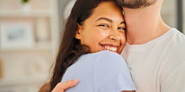 introverted woman showing love and affection hugging her partner