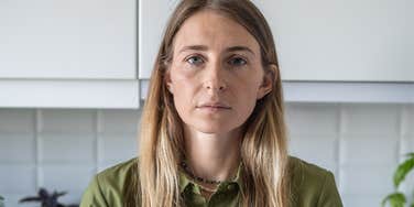 Woman who only thinks of herself standing in a kitchen 