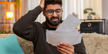 man without health insurance looking at his hospital bill