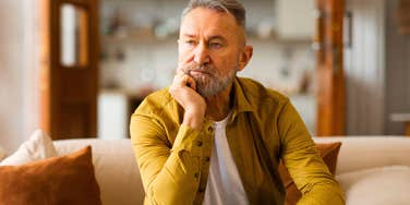 lonely boomer man sitting alone at home thinking