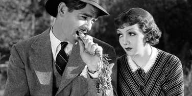 Clark Gable and Claudette Colbert in a scene from the 1934 film 'It Happened One Night'; illustrating the 'lost art' of classic romance and the enduring appeal of black-and-white films among movie enthusiasts.