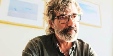 A pensive older man looking discouraged; a visual representation of the 'missed numbers' and economic realities that a CFO warns could make retiring at sixty-five a mistake.