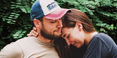 A woman resting her head on her husband in a moment of calm; illustrating the 'charming signs' of a partner whose personality mirrors a German Shepherd’s protective and devoted nature.