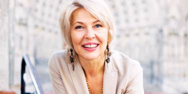 A portrait of a vibrant woman in her mid-fifties, representing the 'biological age' shifts and lifestyle changes that improve energy and mood.