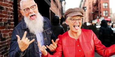 A happy, recently retired couple enjoying a moment together on a New York street; illustrating the vibrant, healthy lifestyle and lasting partnership discussed in their answer about the future.
