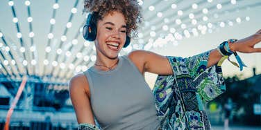 happy woman dancing with headphones on