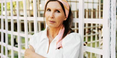 A pensive portrait of a woman in a white dress, illustrating the 'existential loneliness' and internal shift that often occurs in middle and later life.