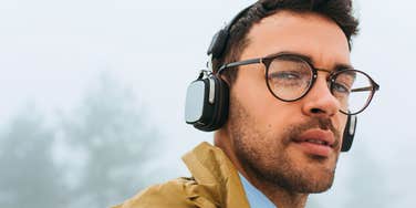 high-iq man with odd habits and behaviors walking with headphones