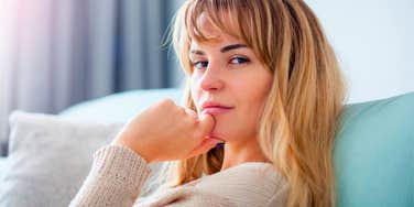 highly intuitive woman sitting pensively at home