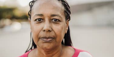 A parent whose adult children resent her looks sternly at the camera 