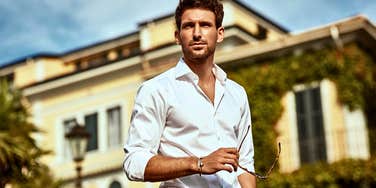 Man who grew up with lots of money standing front of his mansion 