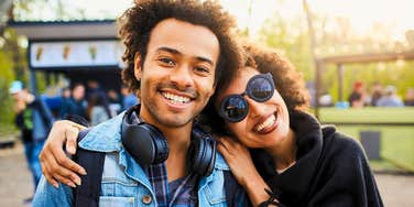 happy youngest sibling being hugged by his mom