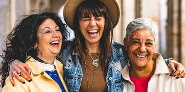 Mom who has a close bond with her adult daughter and sister laughing