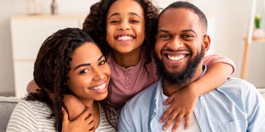 millennial parents with their daughter smiling