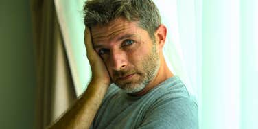 sad man who has zero joy in life isolated at home