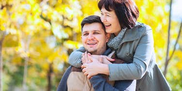 Man who was coddled by his mother is hugged by her in a park 