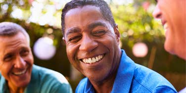 confident man using a deeper voice while talking to his guy friends