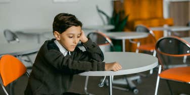little boy in detention after being late to school