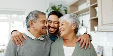 adult man hugging parents