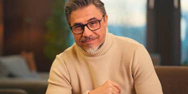 middle aged man with attractive traits smiling confidently