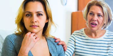 adult woman sitting next to her mother talking to her