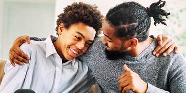 A man and a young boy talking intently together; illustrating the fine line between being a 'friend' and a 'parent' that a coaching expert identifies as a common Gen X struggle.
