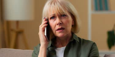 sad older woman on the phone trying to talk to estranged adult children