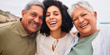 adult woman hugging parents she's extremely close to