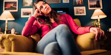 woman sitting in a chair tapping her foot thinking