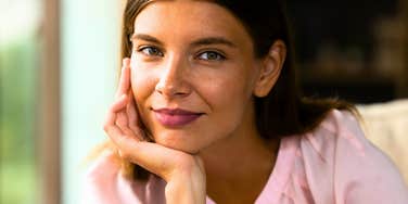 happy emotionally intelligent woman thinking at home