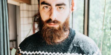 A portrait of a man with a cold, blank expression; illustrating the 'stonewalling' and emotional unavailability that allows a narcissist to never admit they are wrong.