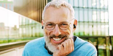 A portrait of a joyful older man in a public setting