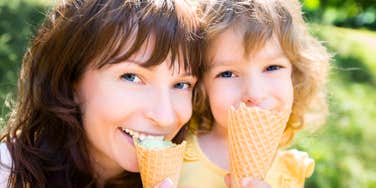 A happy mother and child eating ice cream, illustrating the 'joint attention' and shared joy that build a secure attachment bond.