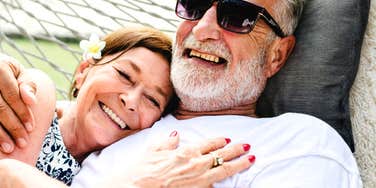 A happy couple in their 60s sharing a playful moment outdoors