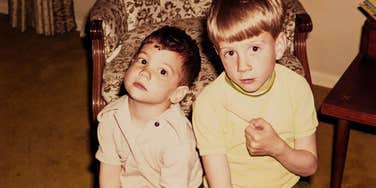 two brothers in the 1960s sitting together