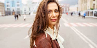 A delighted woman looking directly at the camera walking, capturing the 'radiant energy' and the science-backed daily habit that prevents mid-day fatigue.