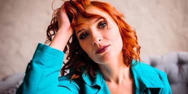 entitled woman touching her hair unwilling to save money