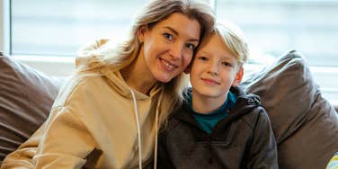 smart parent sitting next to her son teaching him brilliant old-fashioned lessons