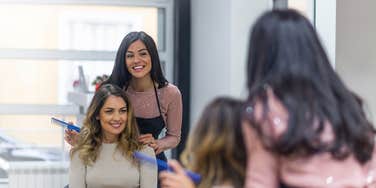 woman getting her hair done by a stylist