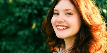 superstitious woman smiling in the sun