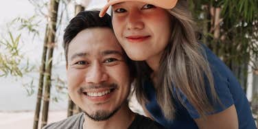 Man who is falling deeply in love with the woman next to him in a bamboo patch