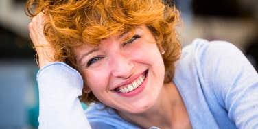 Vibrant woman who is mentally stronger than almost everyone else smiling at camera