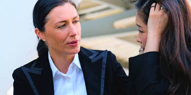 good-hearted woman comforting colleague saying odd phrases to calm her down