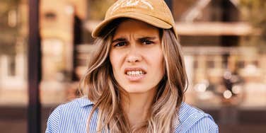 Truly narcissistic woman making a face and not having a good time