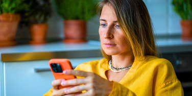 woman using social media on her phone for attention