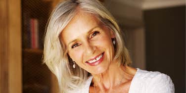 A smiling woman in a study, capturing the 'joy of solitude'