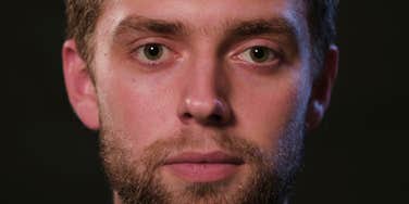 serious narcissistic man staying silent standing in the dark