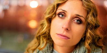 sad woman pretending to be happy with her life