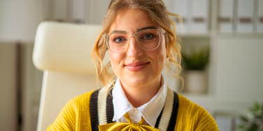 highly intelligent woman sitting at her desk thinking
