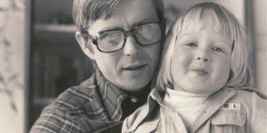 dad holding daughter in the 1970s